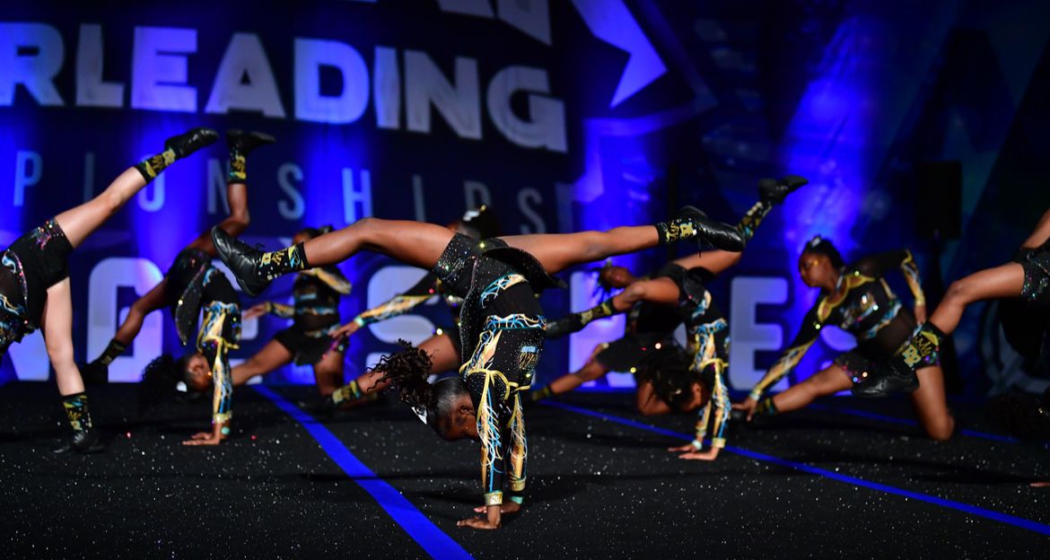 Young athlete practicing back walkover at competition