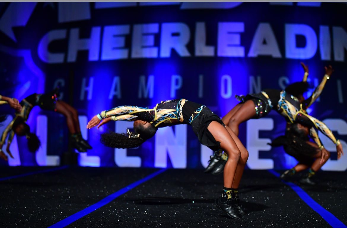 Young athlete performing back handspring at competition